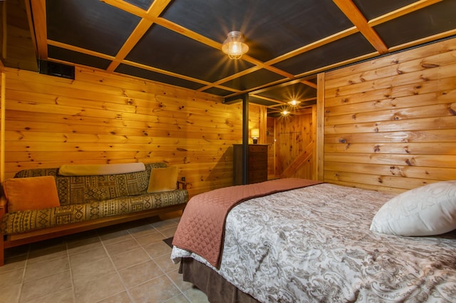 bedroom featuring tile patterned floors, coffered ceiling, and wood walls