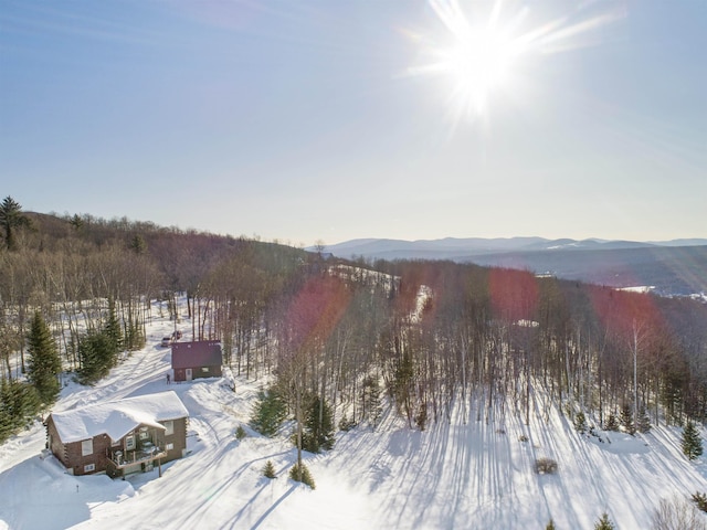 snowy aerial view with a mountain view