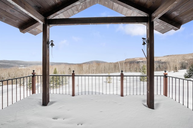 snow covered patio featuring a mountain view