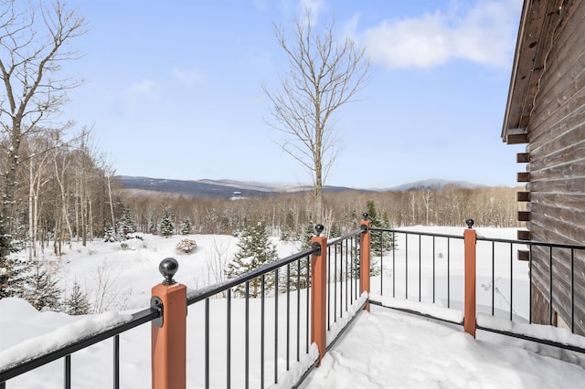 view of snow covered back of property