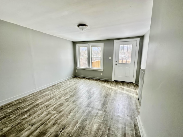 interior space featuring radiator heating unit and light wood-type flooring