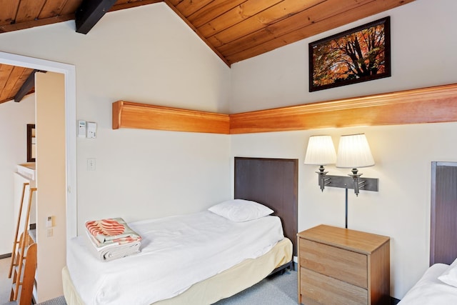 carpeted bedroom with lofted ceiling with beams and wood ceiling