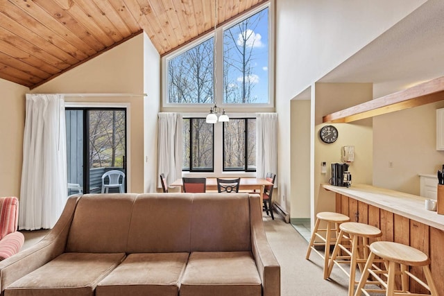 living room with light colored carpet, wooden ceiling, and high vaulted ceiling