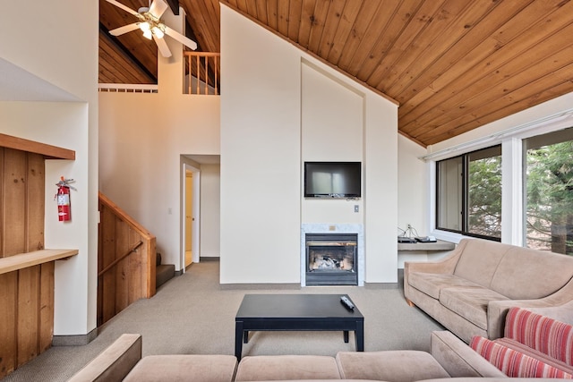 living room with high vaulted ceiling, light carpet, wooden ceiling, and ceiling fan