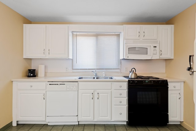 kitchen with white appliances, sink, and white cabinets