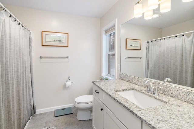 bathroom featuring tile patterned floors, vanity, and toilet