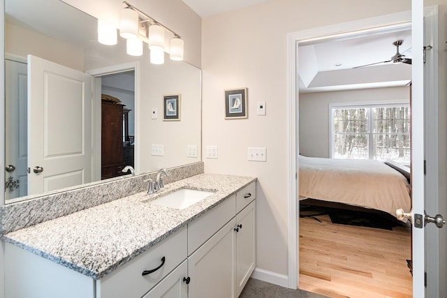 bathroom with vanity, wood-type flooring, and ceiling fan