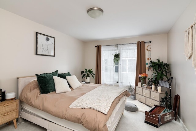 bedroom featuring light carpet