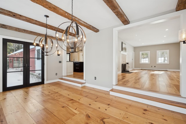 unfurnished dining area with light hardwood / wood-style flooring, an inviting chandelier, a baseboard heating unit, french doors, and beamed ceiling