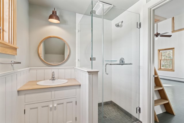 bathroom with a baseboard radiator, vanity, and walk in shower