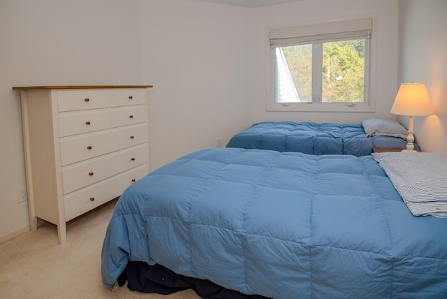 bedroom with light colored carpet