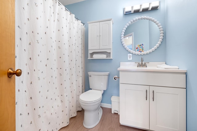 bathroom with vanity, hardwood / wood-style floors, a shower with curtain, and toilet