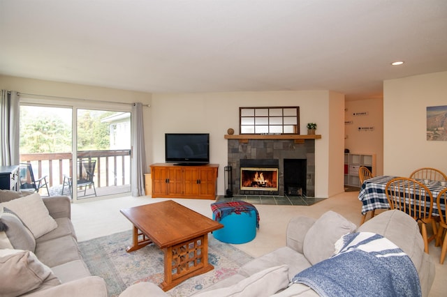 living room with light carpet and a stone fireplace