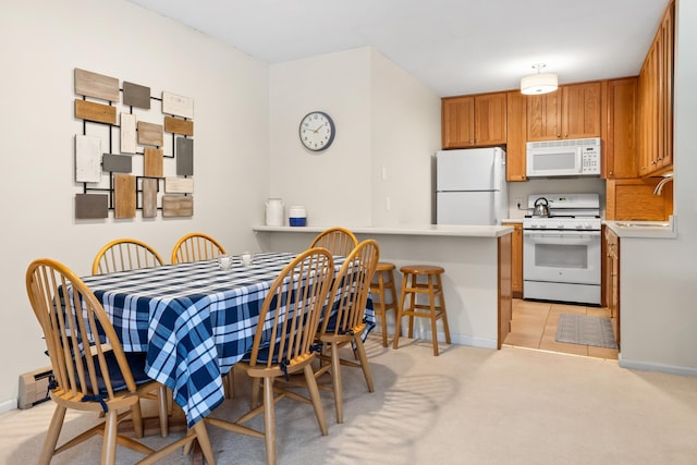 carpeted dining room featuring sink