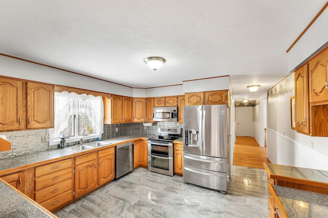 kitchen featuring sink, decorative backsplash, and stainless steel appliances