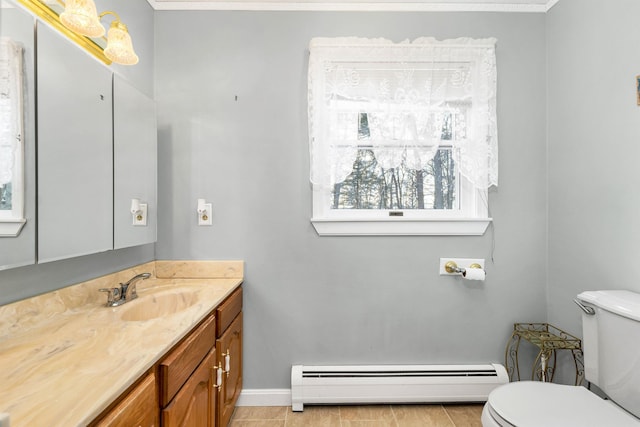 bathroom with vanity, toilet, and baseboard heating