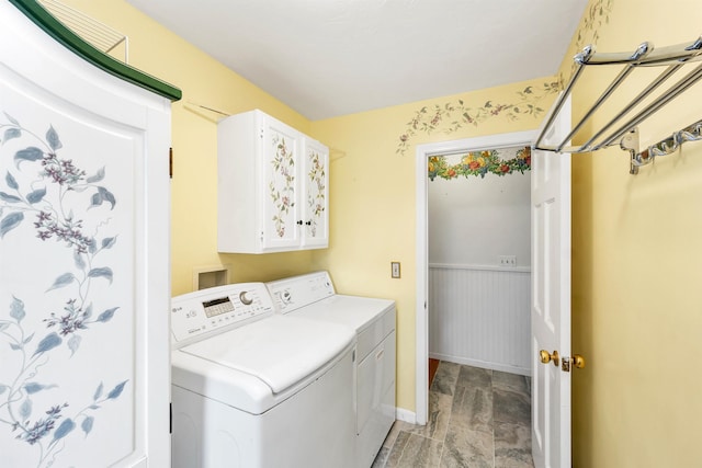 clothes washing area with cabinets and washer and dryer