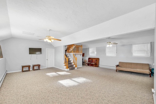 interior space with vaulted ceiling, carpet, ceiling fan, and a textured ceiling