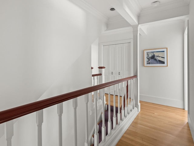 hall with ornamental molding and light hardwood / wood-style flooring