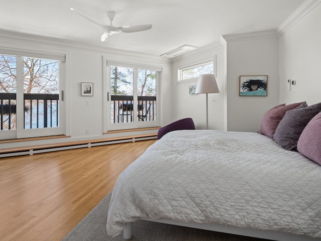 bedroom with ceiling fan, ornamental molding, wood-type flooring, and a baseboard heating unit