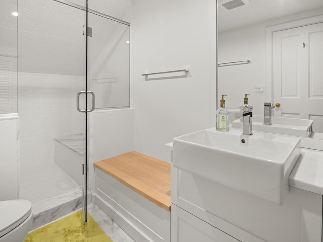 bathroom featuring walk in shower, vanity, and toilet