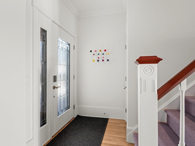 entryway featuring hardwood / wood-style floors and crown molding