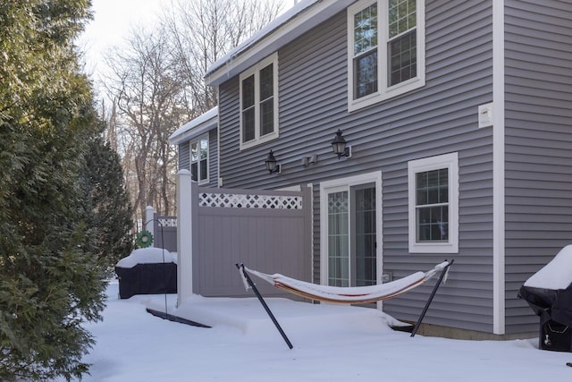 view of snow covered rear of property