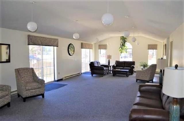 living room featuring a baseboard radiator, lofted ceiling, and carpet