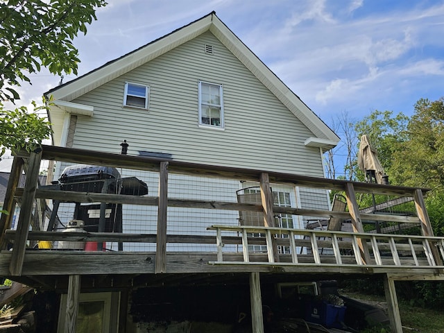 back of house featuring a wooden deck