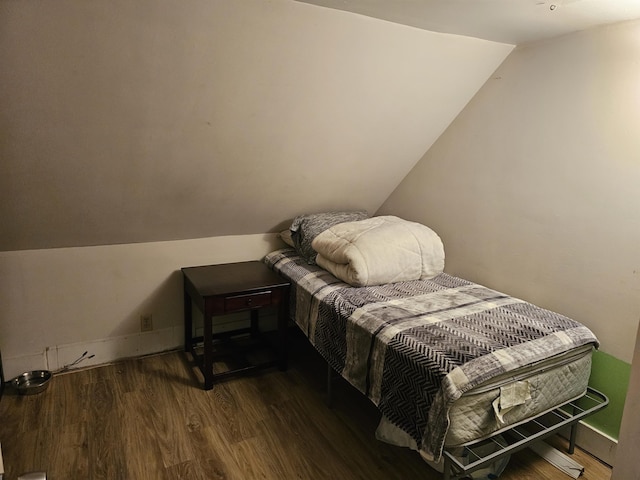 bedroom featuring lofted ceiling and dark wood-type flooring