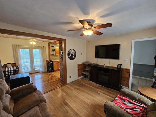 living room featuring light hardwood / wood-style flooring, french doors, and ceiling fan