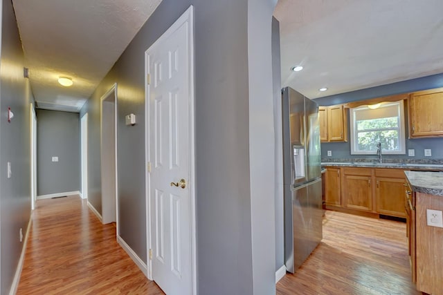 interior space featuring sink and light wood-type flooring