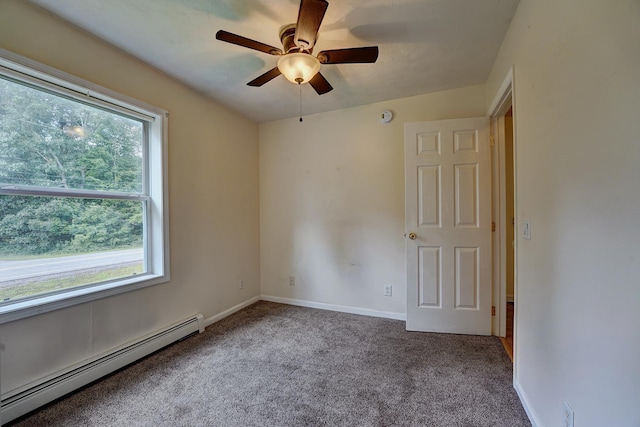 carpeted empty room with ceiling fan and a baseboard radiator