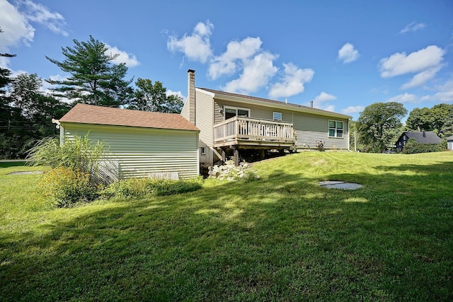 back of house featuring a wooden deck and a yard