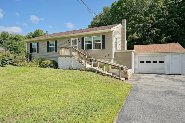 view of front of house with a garage, an outdoor structure, and a front lawn