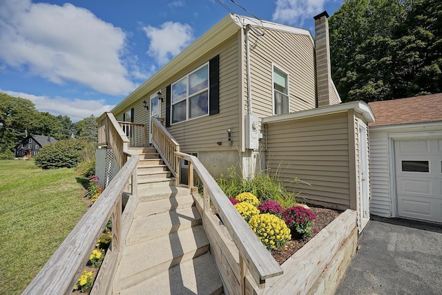 view of side of home with a yard