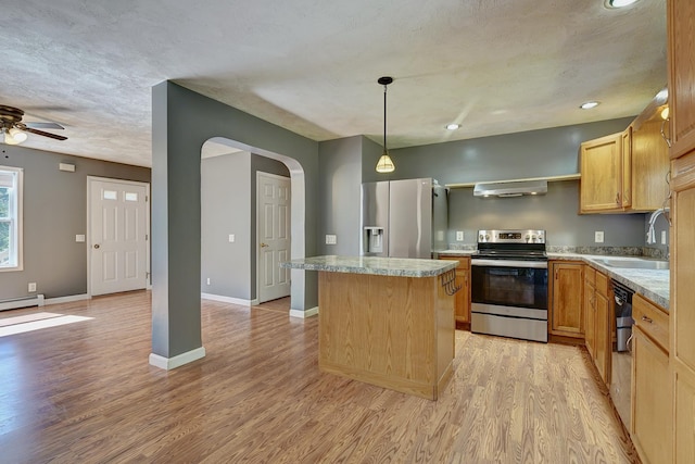 kitchen with sink, light hardwood / wood-style flooring, appliances with stainless steel finishes, ventilation hood, and a kitchen island