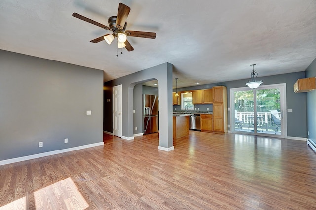 unfurnished living room featuring ceiling fan and light wood-type flooring