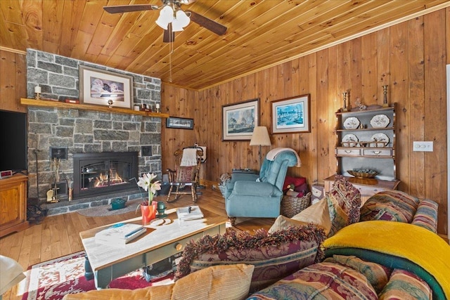 living room with wood walls, a fireplace, hardwood / wood-style floors, and wooden ceiling