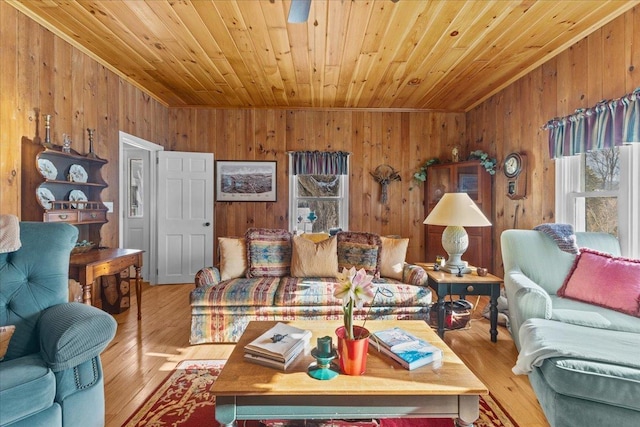 living room featuring wooden ceiling, wood walls, and light wood-type flooring