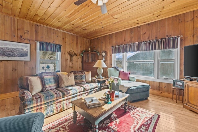 living room with ceiling fan, light wood-type flooring, a wealth of natural light, and wood ceiling