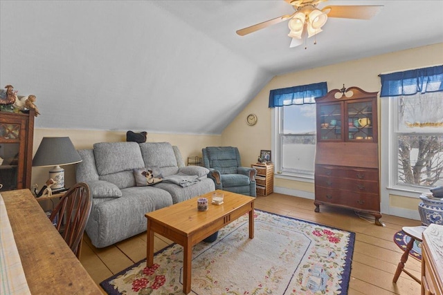 living room with lofted ceiling, light hardwood / wood-style floors, and ceiling fan