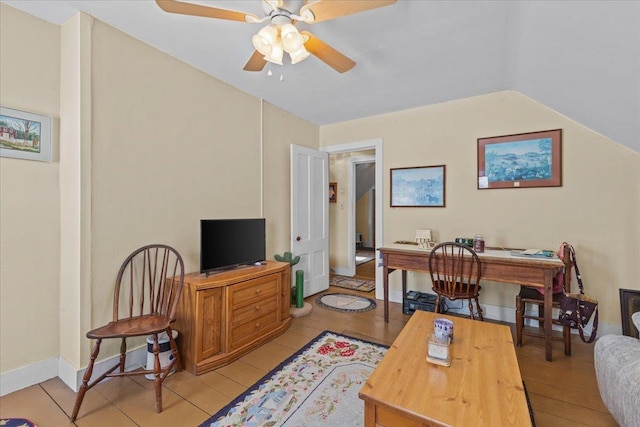 living room featuring vaulted ceiling, ceiling fan, and light hardwood / wood-style flooring