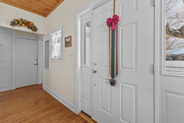 hall with wood ceiling and light wood-type flooring