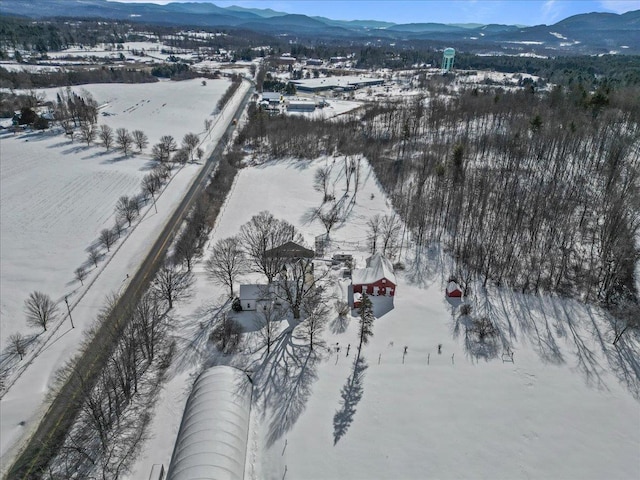 snowy aerial view with a mountain view