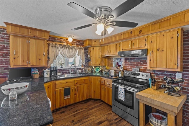 kitchen with dark hardwood / wood-style flooring, sink, stainless steel electric range, and brick wall