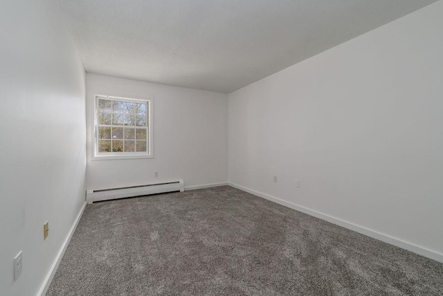 carpeted empty room with a baseboard heating unit