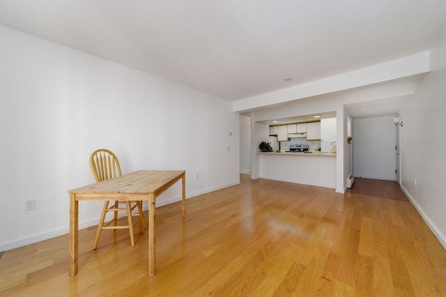 interior space with baseboard heating and light hardwood / wood-style flooring