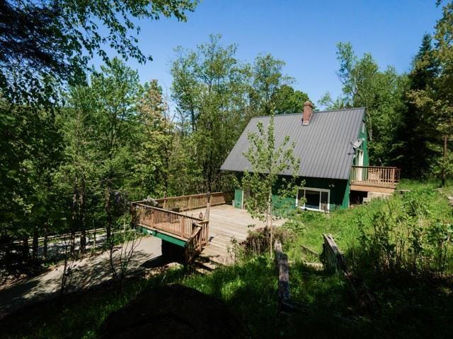 rear view of property featuring a wooden deck