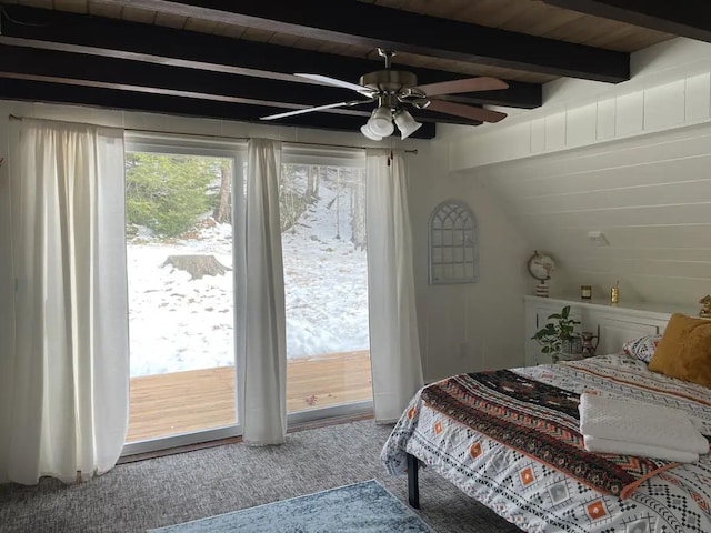 carpeted bedroom with access to outside and beamed ceiling